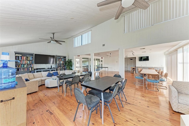 dining room featuring ceiling fan, visible vents, vaulted ceiling, and wood finished floors