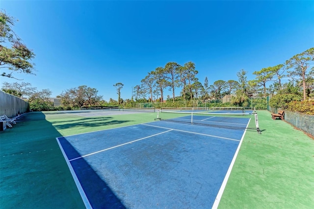 view of tennis court featuring fence