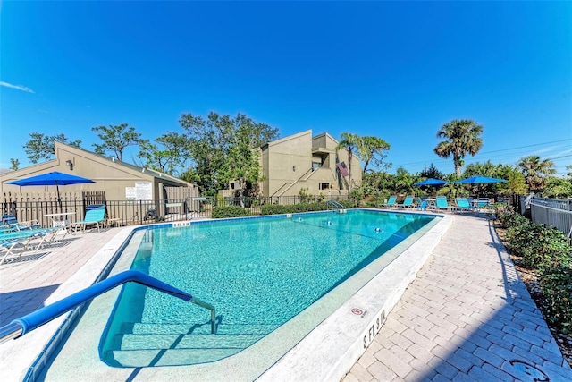 pool featuring a patio area and fence