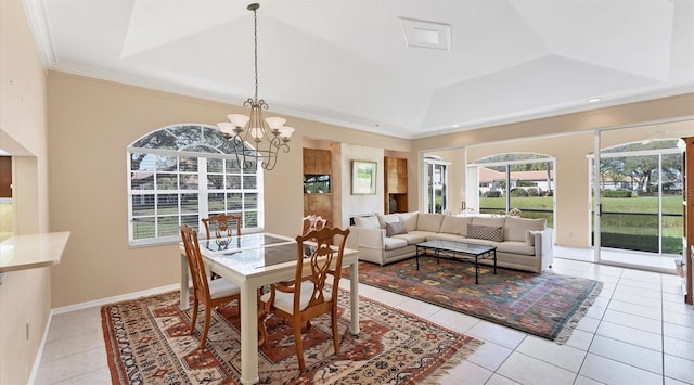 tiled dining space with ornamental molding, an inviting chandelier, and a raised ceiling