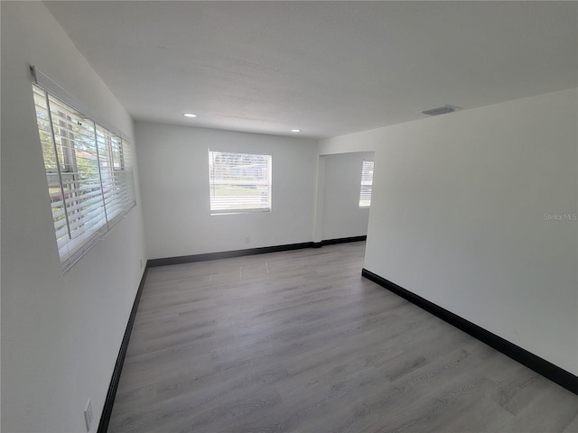 empty room with light hardwood / wood-style flooring