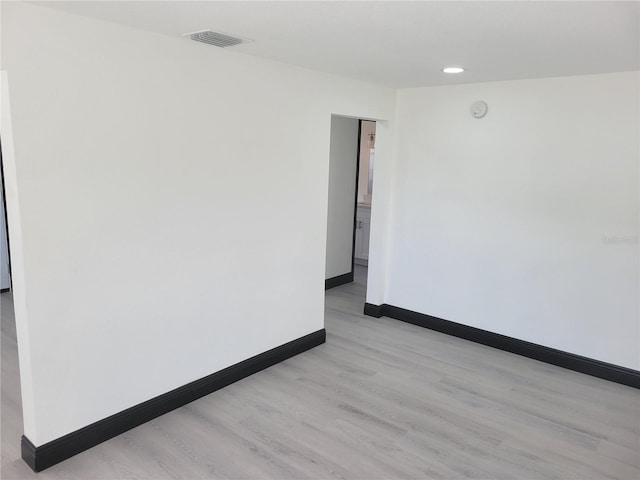 spare room with light wood-type flooring