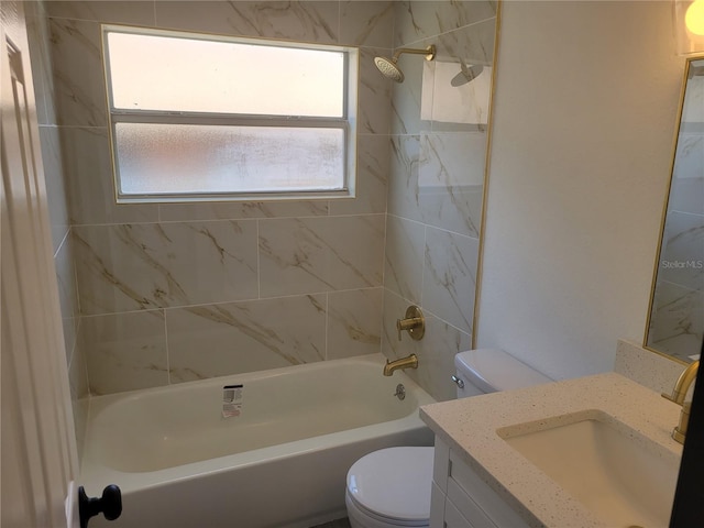 full bathroom with toilet, vanity, and tiled shower / bath