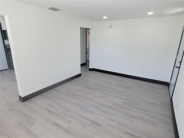 unfurnished room with light hardwood / wood-style floors