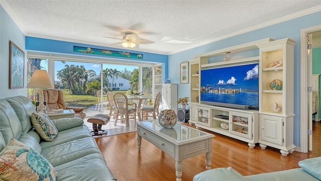 living room with crown molding, ceiling fan, wood-type flooring, and a textured ceiling