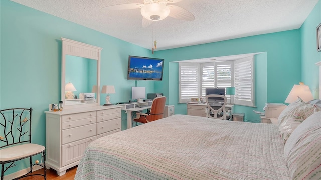 bedroom featuring ceiling fan, a textured ceiling, and light hardwood / wood-style flooring