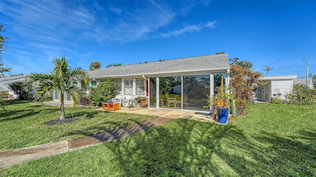 rear view of property featuring a lawn