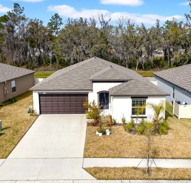 view of front of home featuring a garage and a front lawn