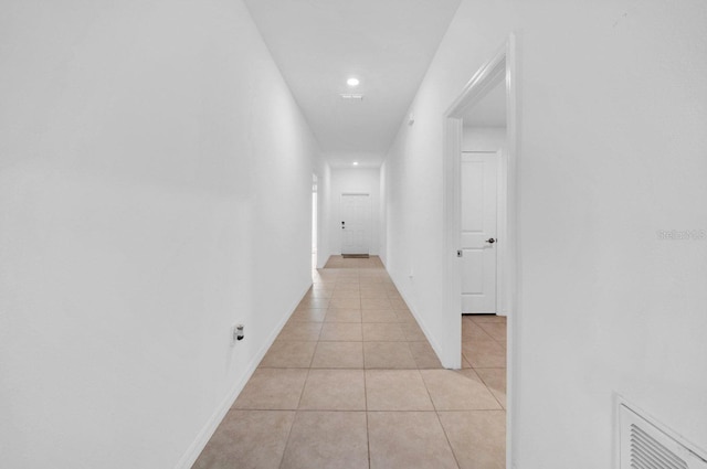 corridor featuring light tile patterned floors