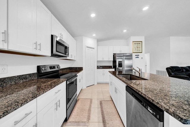 kitchen featuring sink, light tile patterned flooring, white cabinetry, and stainless steel appliances