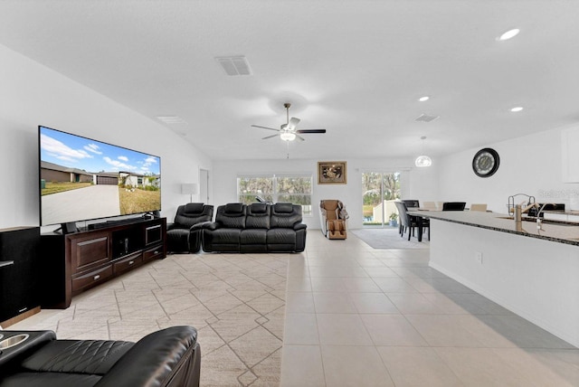 tiled living room featuring sink and ceiling fan