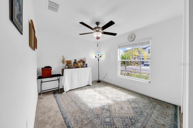 interior space featuring ceiling fan and light colored carpet