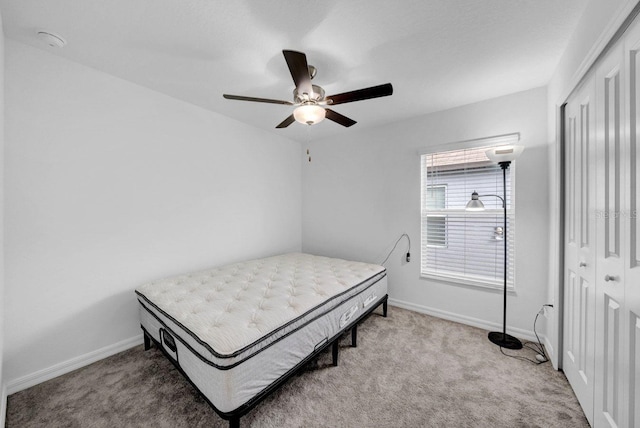 bedroom featuring ceiling fan, a closet, and carpet floors