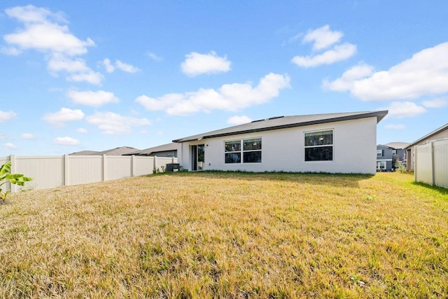 back of house with a lawn