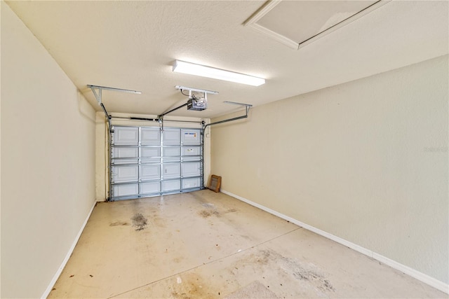 garage with a garage door opener and baseboards