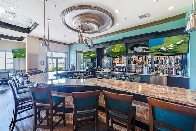 bar with french doors, hanging light fixtures, ornamental molding, dark tile patterned floors, and light stone countertops