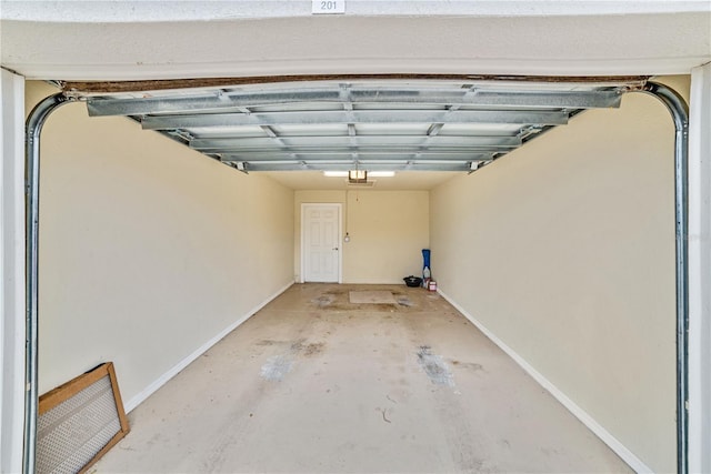 garage with baseboards and a garage door opener