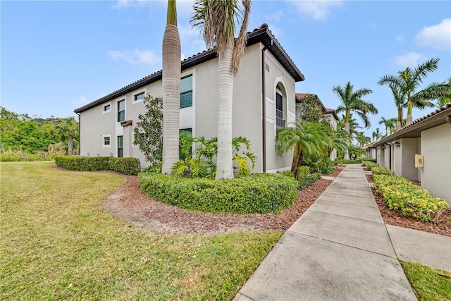 view of property exterior with a lawn