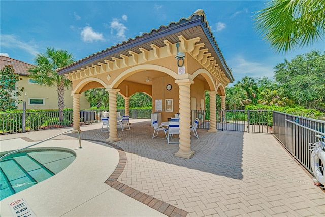 view of property's community with a swimming pool, fence, outdoor dining area, and a patio