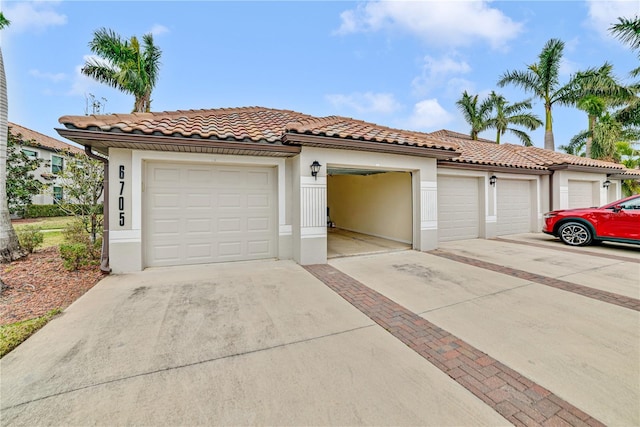 mediterranean / spanish house with a tiled roof and stucco siding