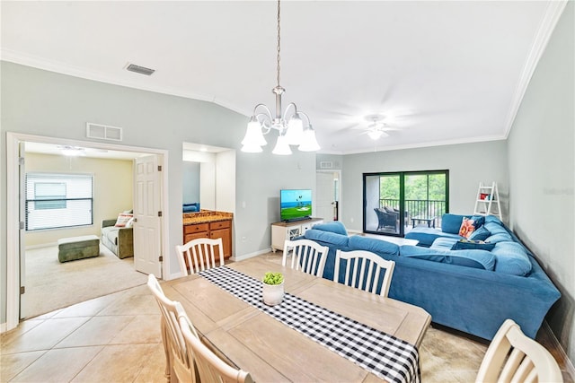 dining space featuring light tile patterned floors, baseboards, visible vents, and crown molding