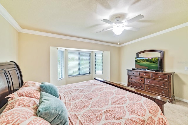 bedroom featuring light carpet, ceiling fan, baseboards, and crown molding