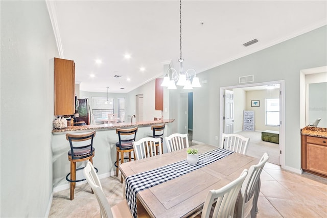 dining space with light tile patterned floors, ornamental molding, visible vents, and baseboards