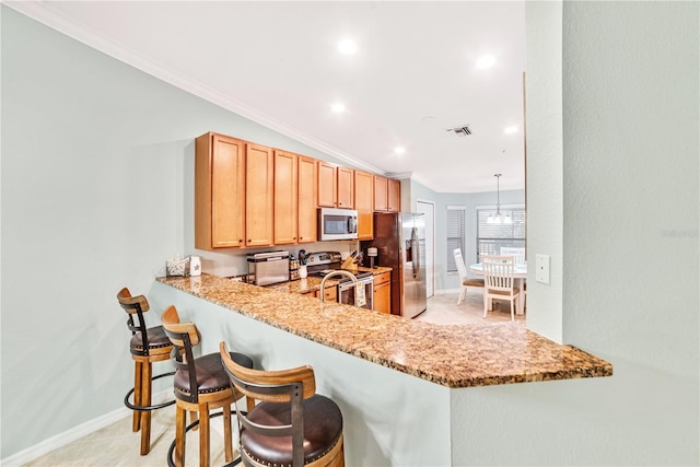 kitchen with visible vents, appliances with stainless steel finishes, hanging light fixtures, a peninsula, and crown molding