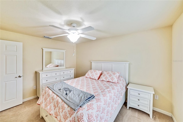 bedroom featuring light carpet, a ceiling fan, visible vents, and baseboards