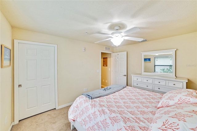 bedroom with light carpet, baseboards, visible vents, and ceiling fan