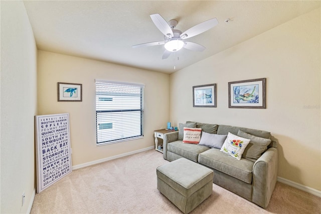 living room featuring baseboards, a ceiling fan, and light colored carpet