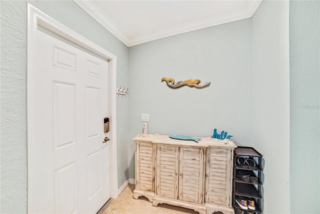 entrance foyer featuring ornamental molding and baseboards