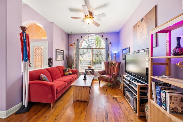 living room featuring hardwood / wood-style floors and ceiling fan