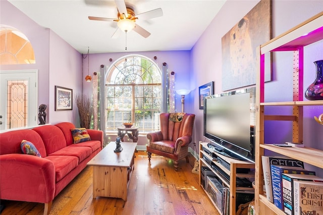 living room with light hardwood / wood-style floors and ceiling fan