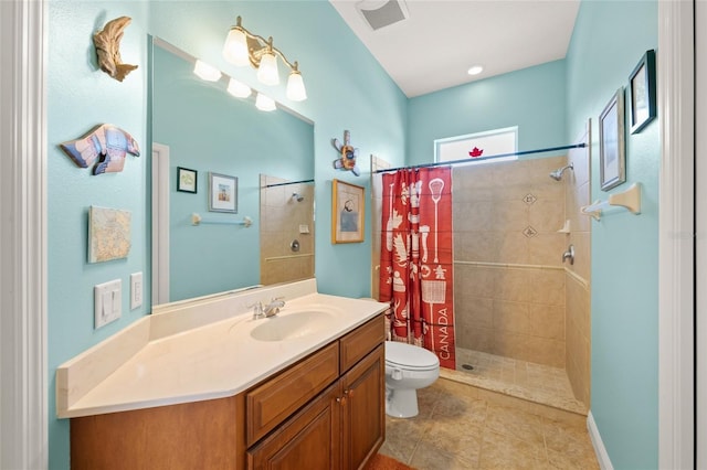 bathroom with tile patterned floors, vanity, toilet, and curtained shower