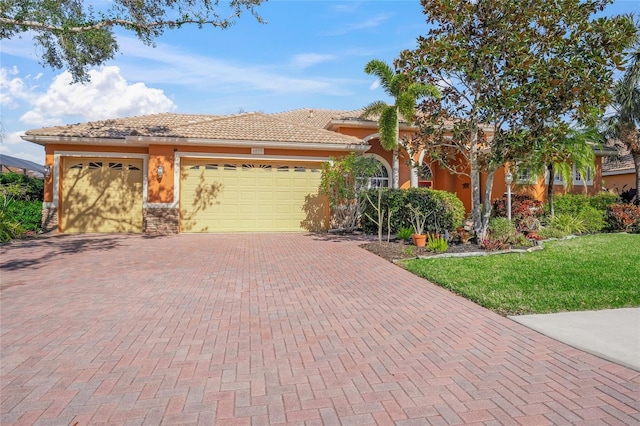 mediterranean / spanish-style house with a garage and a front yard