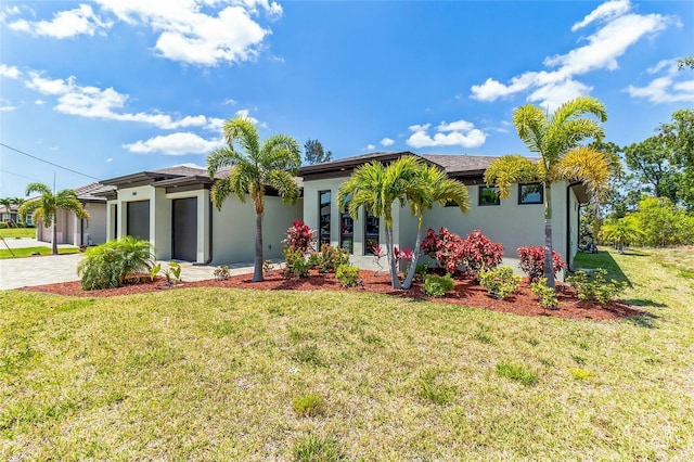 view of front of property with a front lawn and a garage