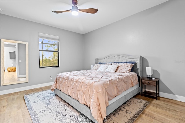 bedroom with ceiling fan and light hardwood / wood-style flooring