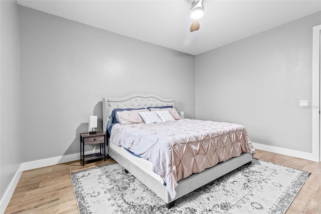 bedroom with ceiling fan and hardwood / wood-style floors