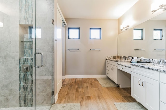 bathroom featuring an enclosed shower, vanity, and hardwood / wood-style floors