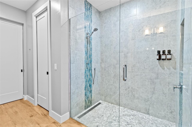 bathroom featuring an enclosed shower and wood-type flooring