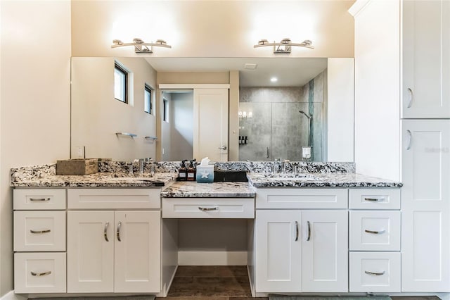 bathroom with hardwood / wood-style flooring, an enclosed shower, and vanity