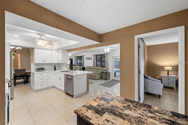 kitchen featuring kitchen peninsula, dishwasher, sink, white cabinets, and light tile patterned floors