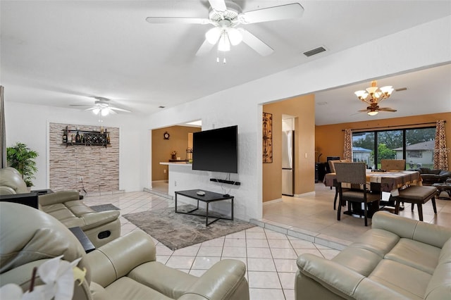 living room with ceiling fan with notable chandelier and light tile patterned flooring