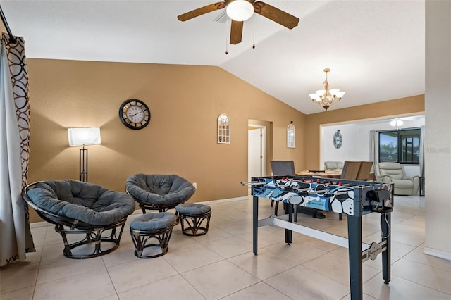 game room with ceiling fan with notable chandelier, light tile patterned floors, and lofted ceiling