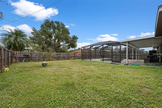 view of yard with glass enclosure, a fenced in pool, and a patio