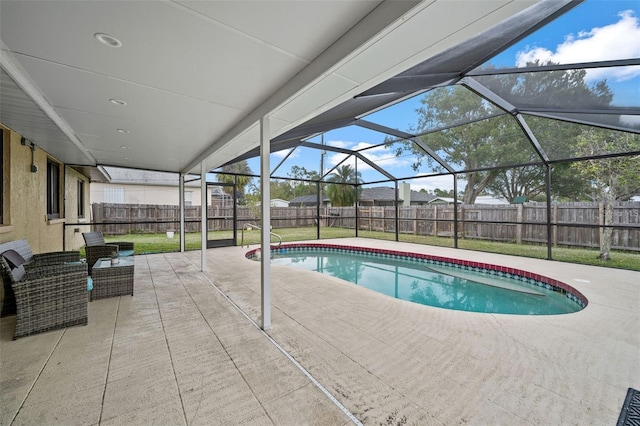 view of swimming pool featuring a lanai and a patio area