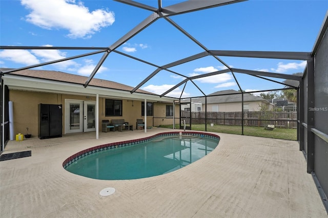 view of swimming pool featuring a lanai and a patio