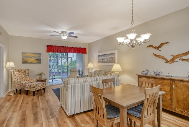 dining room featuring ceiling fan with notable chandelier and light hardwood / wood-style floors