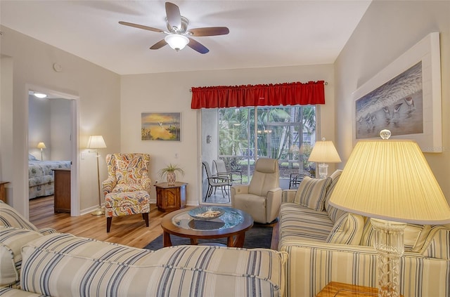 living room featuring ceiling fan and hardwood / wood-style floors